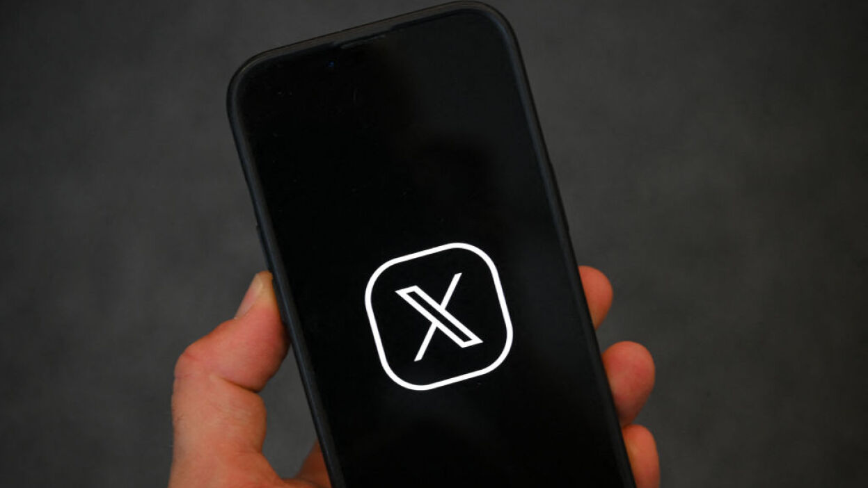 X logo on phone screen