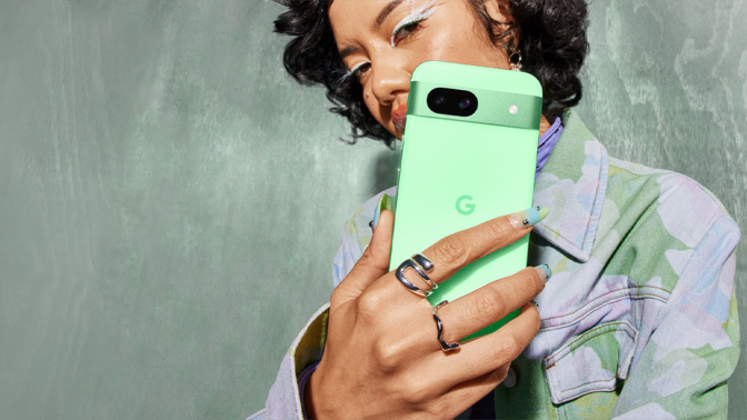 girl holding aloe google pixel 8a phone with colorful shirt and nails