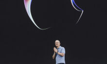 Apple CEO Tim Cook with his hands together on stage at WWDC 2023