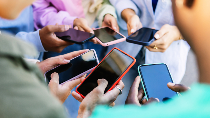 Teen friends watching social media content on smartphone app. 