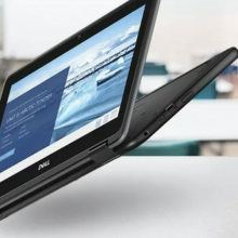 Dell 2-in-1 Chromebook shown hovering in the air above desks in a school setting