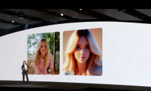 A picture from the Samsung event stage, with a screen in the background displaying Sydney Sweeney and a digital avatar of the actress.