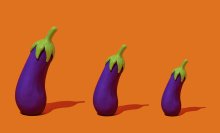three fake eggplants of different sizes, arranged from largest to smallest, standing on an orange background