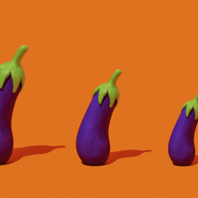 three fake eggplants of different sizes, arranged from largest to smallest, standing on an orange background