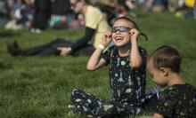 Child watching a total solar eclipse