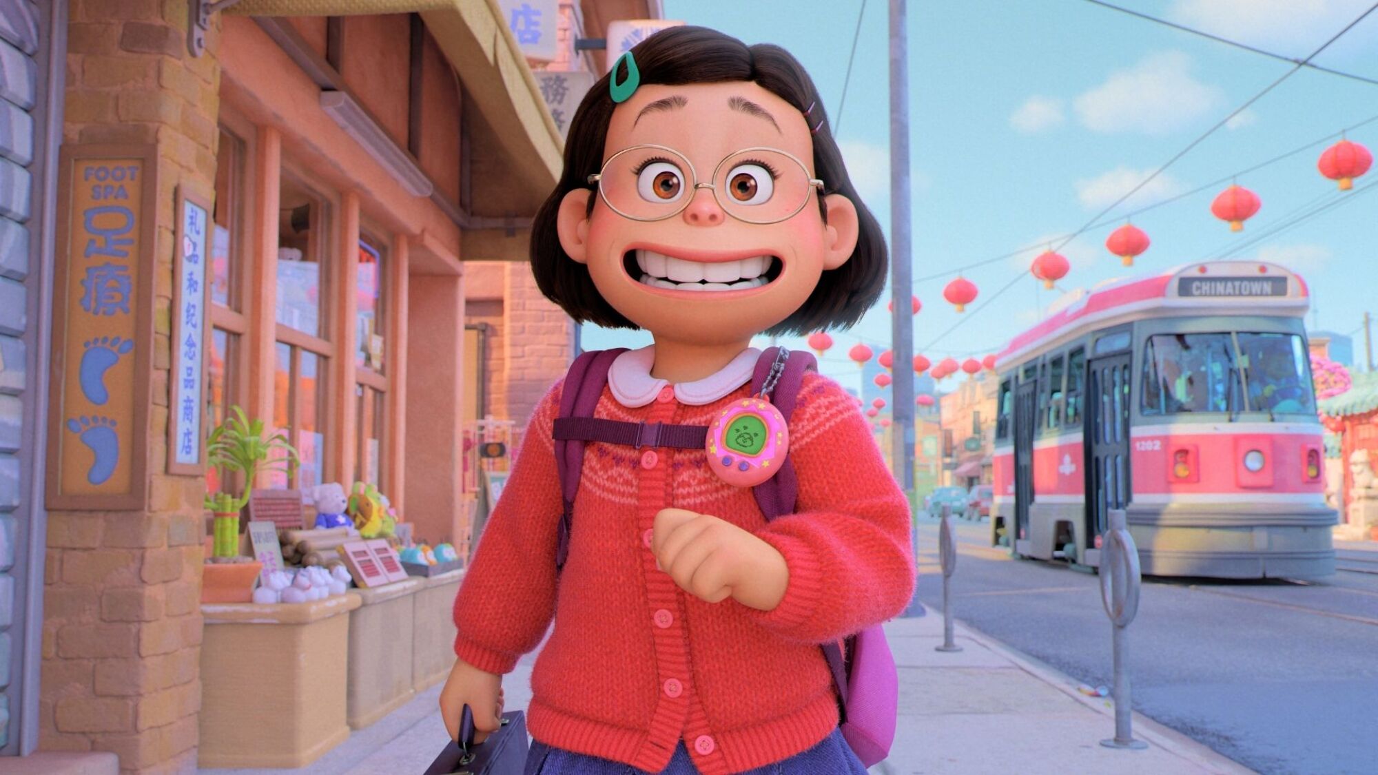 A little bespectacled girl walks down a Toronto street. 