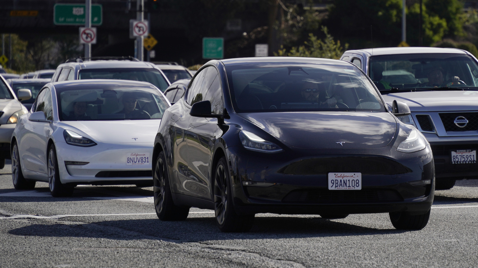 Tesla vehicles drive on the street on February 2, 2024 in San Bruno, California. 