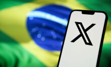 X app in front of Brazilian flag