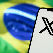 X app in front of Brazilian flag