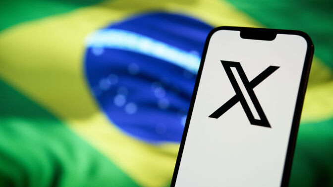 X app in front of Brazilian flag