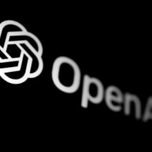 OpenAI logo displayed on a phone screen in this illustration