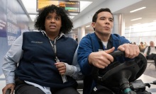 Mel and Rory race through JFK airport on a cart.