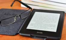 LONDON - JULY 16: Amazon Kindle paper white e book reader. July 16, 2014 in London, UK.