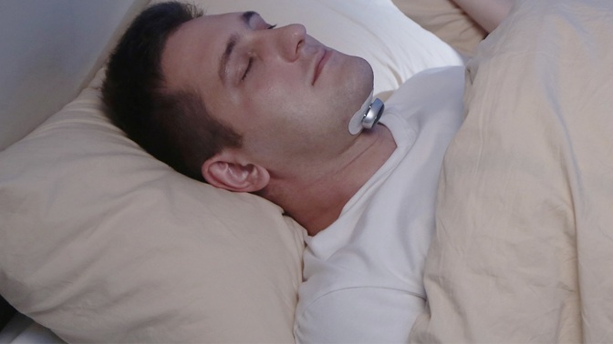 Person using the Snore Circle Smart Electronic Muscle Stimulator to sleep.