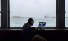 person on ferry working on m3 macbook pro