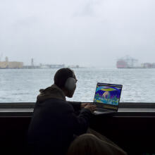 person on ferry working on m3 macbook pro