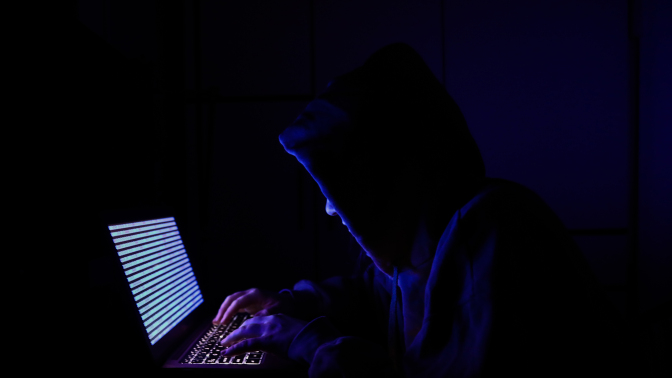 A person dressed as an internet hacker