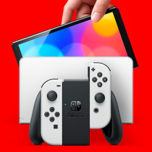 a person holding a nintendo switch oled model above its charging dock against a bright red background