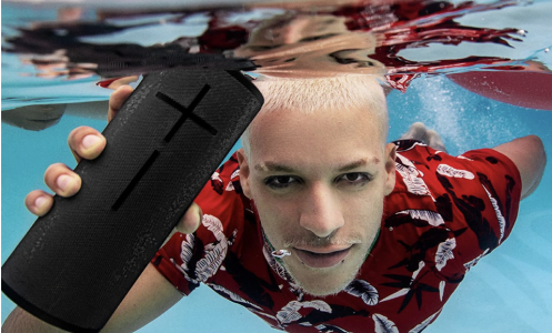 man holding a speaker under water