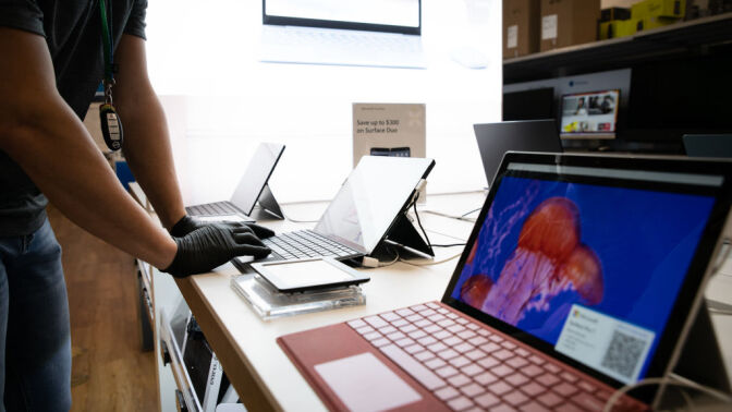 Worker at laptop store.