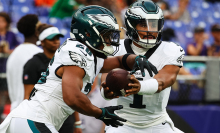 Jalen Hurts of the Philadelphia Eagles hands the ball off