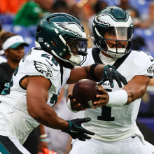 Jalen Hurts of the Philadelphia Eagles hands the ball off