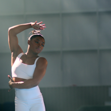 Simone Biles in a dance pose in a studio.