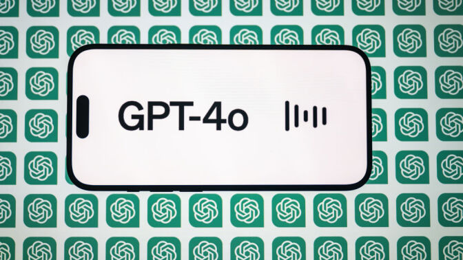  the 'Chat GPT-4o' logo is displayed on a mobile phone screen in front of a computer screen displaying the 'Chat GPT' logo