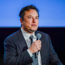 Elon Musk on stage at an event