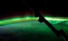 Watch as auroras dance with the International Space Station