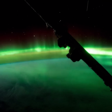 Watch as auroras dance with the International Space Station