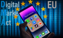 A phone displaying an applications folder in front of the European Union symbol. 