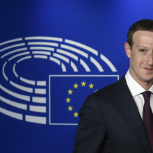 Mark Zuckerberg stands in front of the European Union logo.