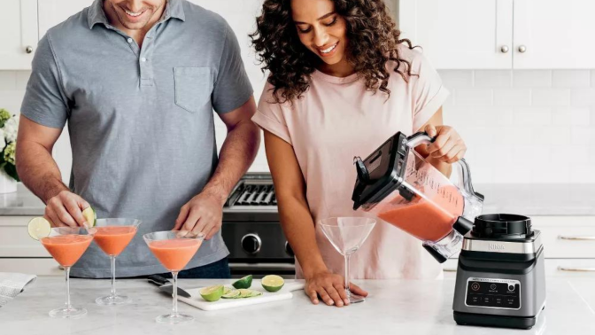 couple making frozen drinks with Ninja Professional Plus Duo blender