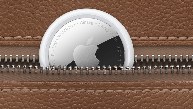 close-up of Apple AirTag tucked into leather luggage