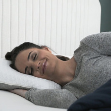 Woman sleeping on a CarbonIce pillow.