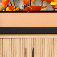 An Amazon Fire TV soundbar sits on a TV stand 
