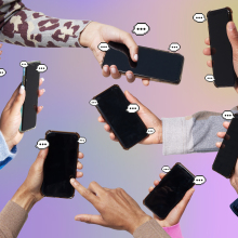 Hands holding smartphones with speech bubbles