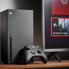 an xbox series x sits on a table next to a TV