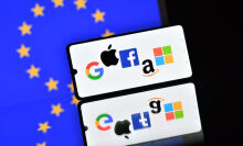 App icons on phone in front of EU Flag