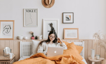 Person in bed looking at computer