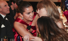 Selena Gomez whispers in Taylor Swift's ear at the 2024 Golden Globes.