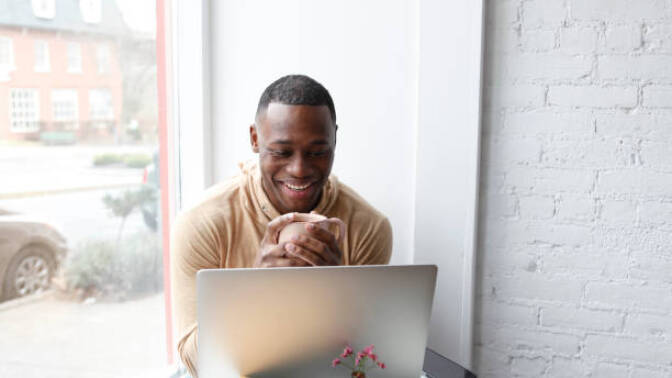 Man using ChatGPT while having coffee.