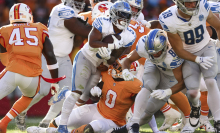 Several Lions and Bucs players colliding together during a play.