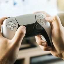 a person holding a playstation controller