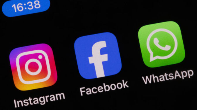 Instagram, Facebook, and WhatsApp icons on a smartphone screen