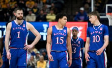 Hunter Dickinson, Kevin McCullar Jr. and Johnny Furphy of the Kansas Jayhawks walk down the court during the game against the West Virginia Mountaineers at WVU Coliseum on January 20, 2024, in Morgantown, West Virginia.