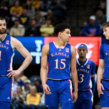 Hunter Dickinson, Kevin McCullar Jr. and Johnny Furphy of the Kansas Jayhawks walk down the court during the game against the West Virginia Mountaineers at WVU Coliseum on January 20, 2024, in Morgantown, West Virginia.