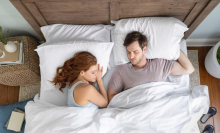 man and woman sleeping on tuft & needle mattress in bedroom