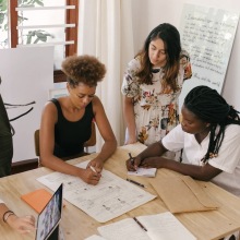 Group of people working together at a table.